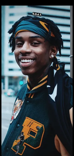 Smiling Polo G In Varsity Jacket Wallpaper