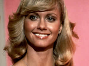 Smiling Portrait Of Olivia Newton John Wallpaper