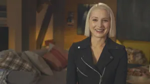 Smiling Woman Black Jacket Interior Setting Wallpaper