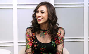 Smiling Woman Floral Dress Interview Setting Wallpaper
