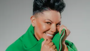 Smiling Womanin Green Coat Wallpaper