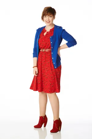 Smiling Womanin Red Dressand Blue Cardigan Wallpaper