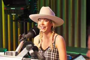 Smiling Womanin White Hatat Radio Station Wallpaper