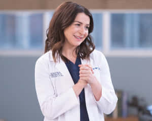 Smiling Womanin White Lab Coat Wallpaper