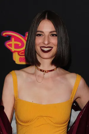 Smiling Womanin Yellow Dressat Event Wallpaper