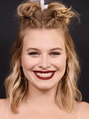 Smiling Womanwith Buns Hairstyleand Red Lipstick Wallpaper