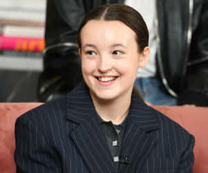 Smiling Young Actressin Striped Blazer Wallpaper