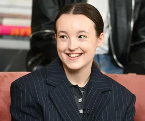 Smiling Young Actressin Striped Blazer Wallpaper