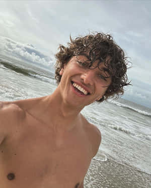 Smiling Young Man Beach Selfie Wallpaper