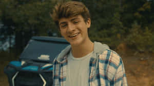 Smiling Young Man Outdoors Wallpaper