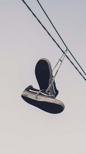 Sneakers Dangling From Powerline Wallpaper