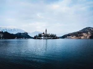 Snow-kissed Julian Alps Encircling Pristine Lake Bled Wallpaper