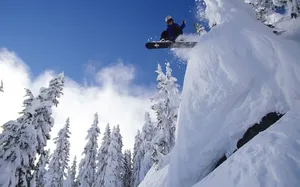 Snowboard Coming Down From High Ledge Wallpaper