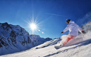 Snowboarder Flying High Over A Snowy Mountain Wallpaper