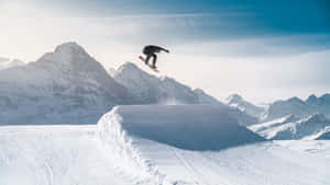 Snowboarder_ Midair_ Mountain_ Backdrop_4 K Wallpaper