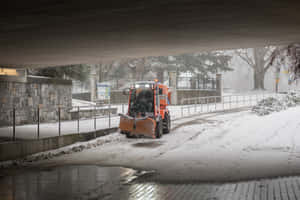 Snowplow Clearing A Mountain Road In Winter Wallpaper