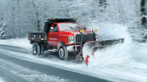 Snowplow Clearing A Snowy Path During Winter Wallpaper