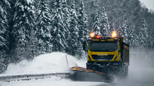 Snowplow Clearing A Snowy Road On A Winter Day Wallpaper