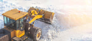 Snowplow Clearing Snow During Winter Wallpaper