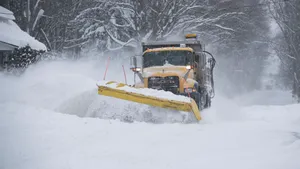 Snowplow Clearing The Road On A Snowy Day Wallpaper
