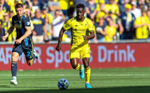 Soccer Action Yellow Blue Uniforms Wallpaper