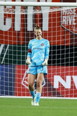 Soccer Goalkeeper Smilingon Field Wallpaper