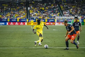 Soccer Match Action Yellowvs Orange Wallpaper