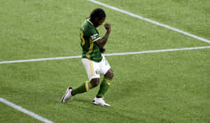 Soccer Player Celebrationon Field Wallpaper