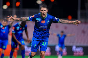 Soccer Player Celebrationon Field Wallpaper