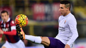 Soccer Player Control Ball During Match Wallpaper