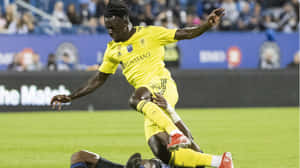 Soccer_ Player_in_ Action_ During_ Match.jpg Wallpaper