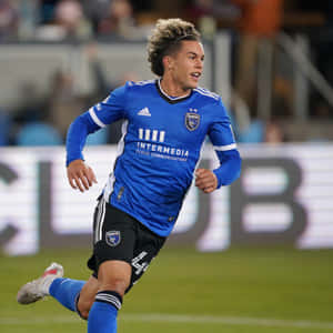 Soccer_ Player_in_ Action_on_ Field Wallpaper