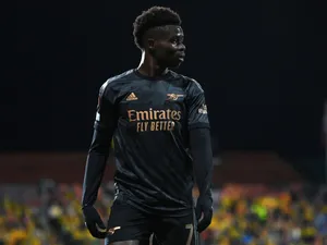 Soccer Player In Black Kit Night Game Wallpaper