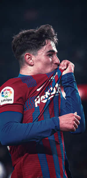 Soccer Player Kissing Badge Wallpaper