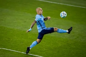 Soccer Player Mid Air Kick Wallpaper