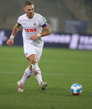 Soccer Playerin Actionon Field.jpg Wallpaper