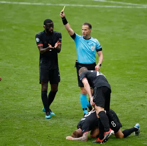 Soccer Referee Issuing Yellow Card Wallpaper