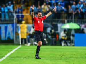 Soccer Referee Signaling During Match.jpg Wallpaper