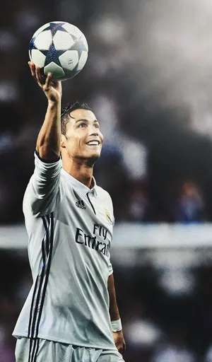 Soccer_ Star_ Holding_ Ball_ Victory_ Pose.jpg Wallpaper