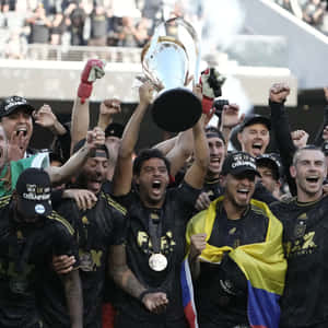 Soccer Team Celebrationwith Trophy Wallpaper