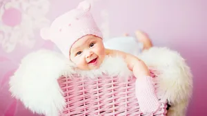 Soft Pink Blanket Wrapped Lovingly Around A Sleeping Baby Girl In The Sunlight. Wallpaper