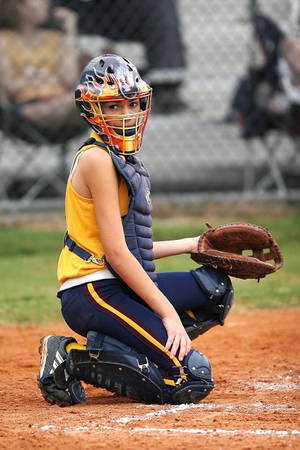 Softball Catcher With Flame Designed Helmet Wallpaper