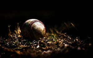 Softball In Pitch Black Night Wallpaper