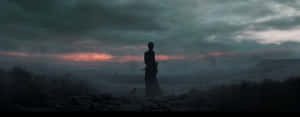 Solitary_ Figure_ Amidst_ Ruins_at_ Dusk Wallpaper