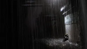 Solitary Person Under Rain Wallpaper