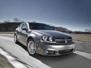 Sophisticated Dodge Avenger Cruising On Highway Wallpaper