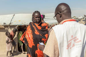 South Sudanese Woman In Vibrant Orange Dress Wallpaper