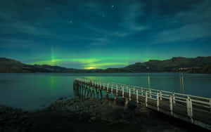 Southern Lights Over Lake With Pier.jpg Wallpaper