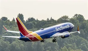 Southwest Airlines Plane Flying Above Trees Wallpaper