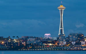 Space Needle Towering Over Buildings Wallpaper